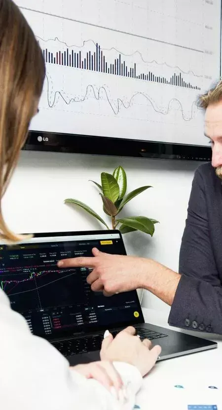 Professionals discussing financial charts and graphs during a business meeting.