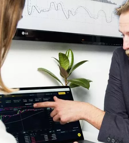 Professionals discussing financial charts and graphs during a business meeting.
